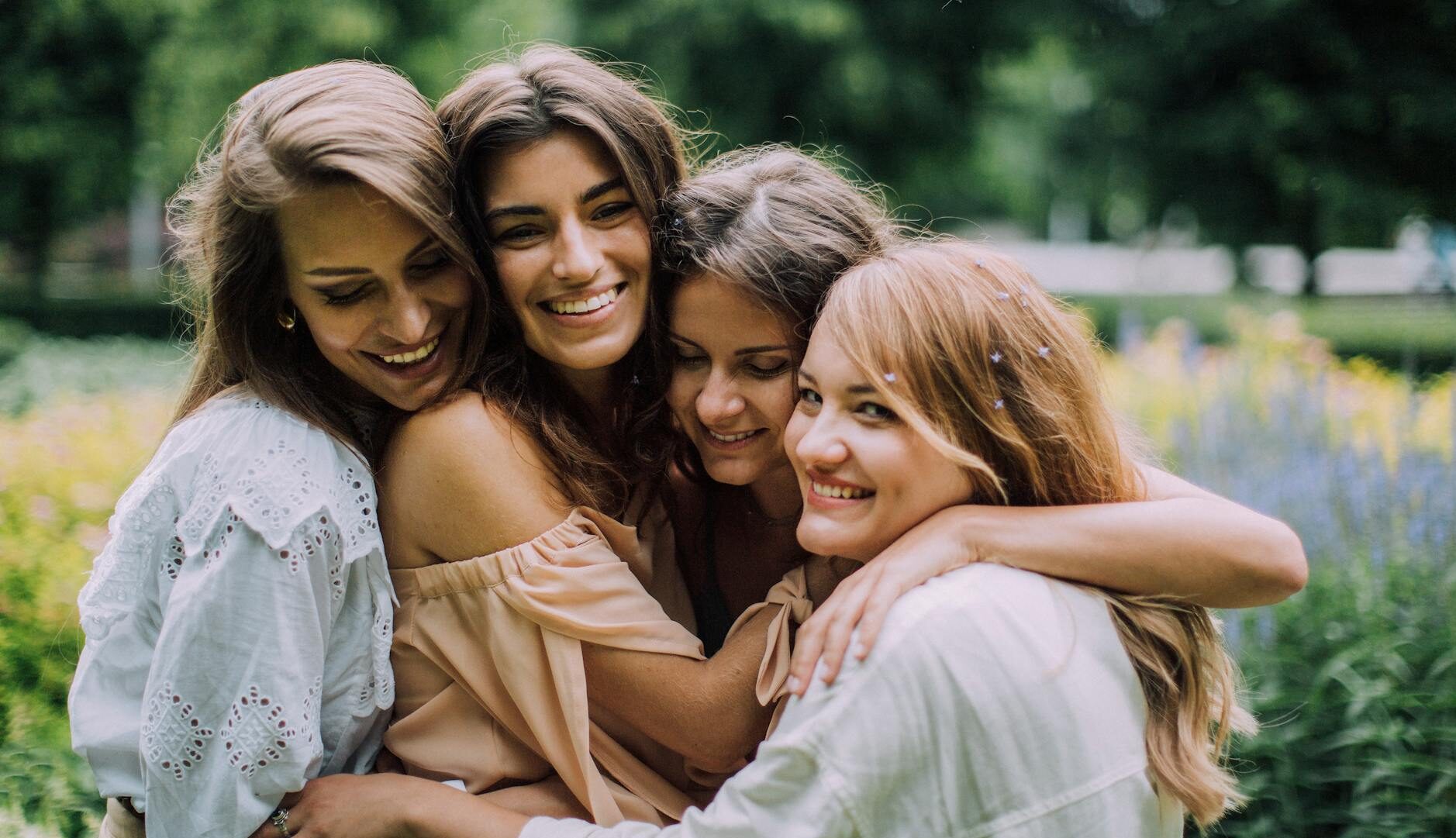 women hugging and smiling